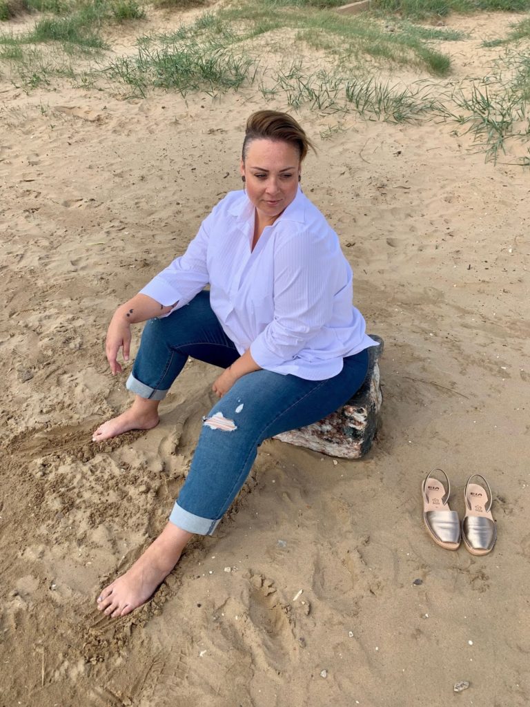 Plus Size woman in casual outfit on beach
