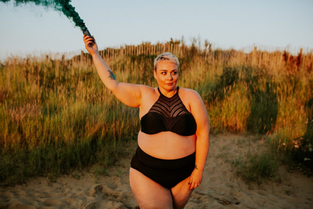 Plus Size woman stood on beach