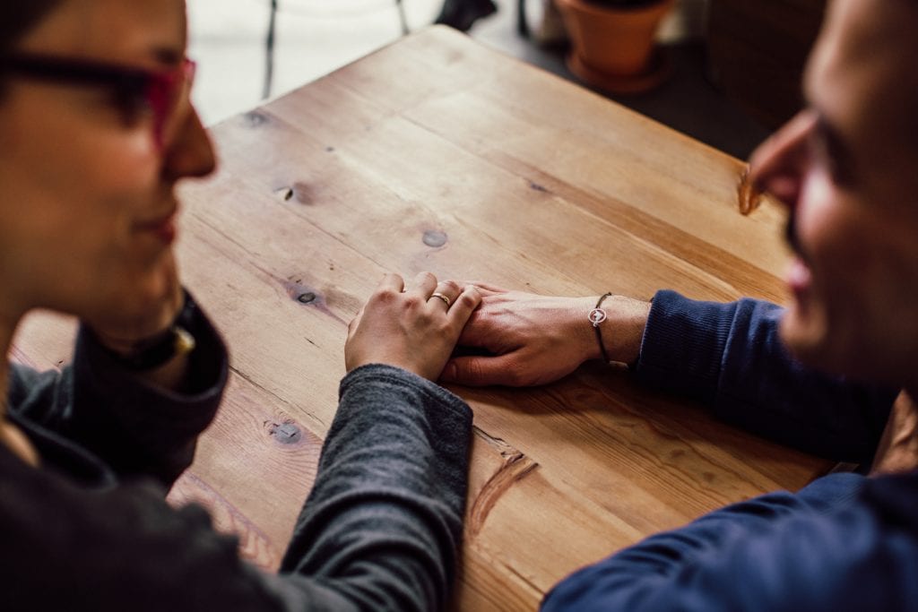 A couple are on a date holding hands